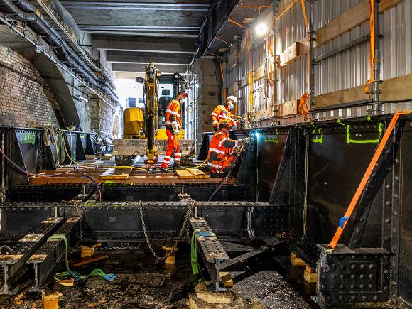 workers cut an iron bridge in pieces