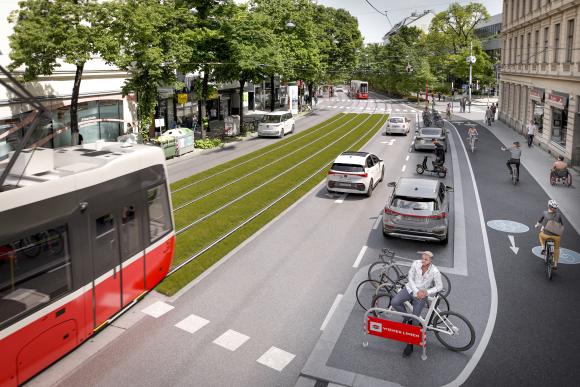 a street with a Flexity streetcar a biking lane and many trees and flower beds