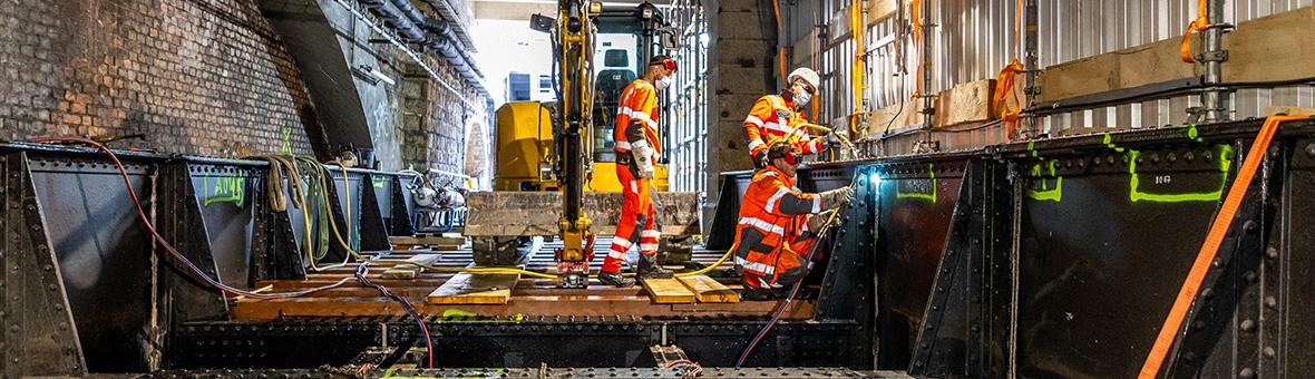 Workers cut up the old steel supporting structure